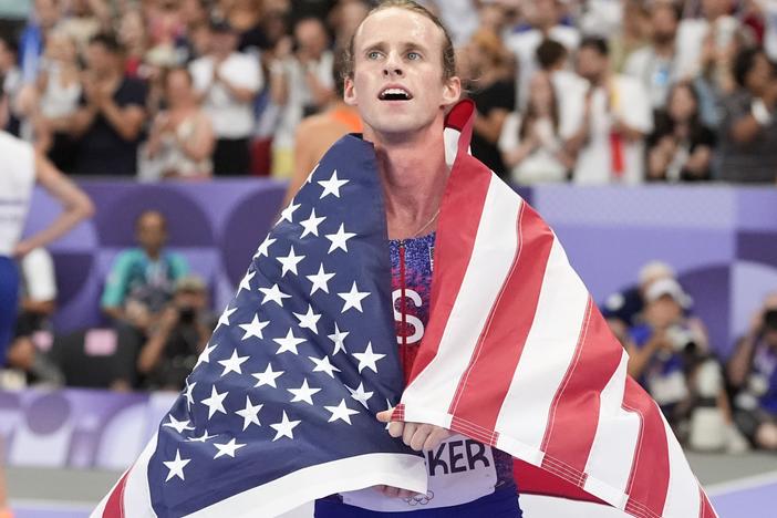 Cole Hocker, of the United States, celebrates setting an Olympic record and winning the men's 1,500-meter final at the Paris Summer Olympics.