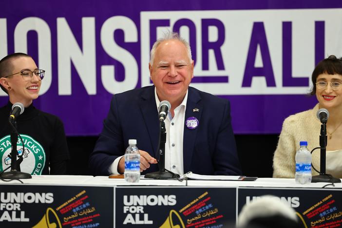 Minnesota Gov. Tim Walz speaks with union organizers before they march on businesses in downtown Minneapolis on Oct. 14, 2022.