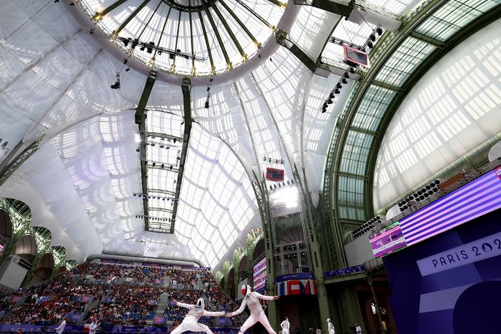 Lee Kiefer of Team United States (L) fought her way to a gold medal in the individual women's foil competition and helped lead her team to a first-ever gold medal against Italy, one of the best fencing teams in the world.