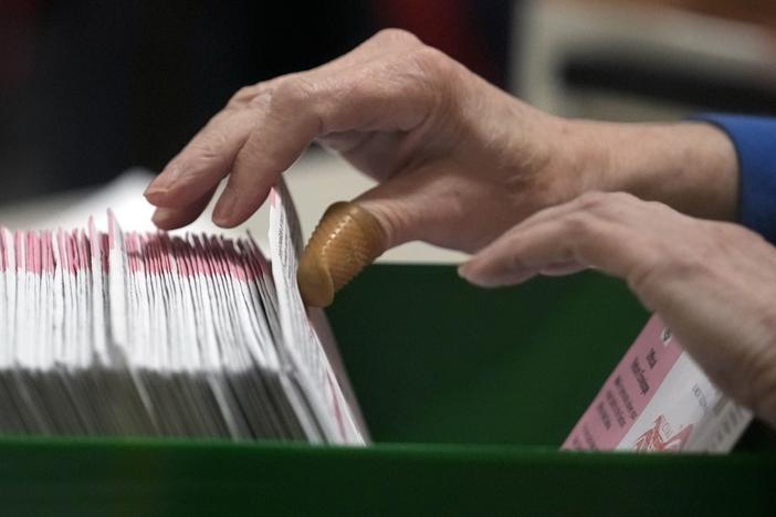 An election worker processes ballots at the Clark County Election Department in Las Vegas on Nov. 10, 2022.