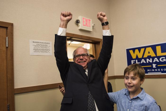 Then-Minnesota Democratic Rep. Tim Walz and his son Gus Walz celebrate while entering his election night party in August 2018 in St. Paul, Minn. Walz won the night's primary and went on to be elected governor.