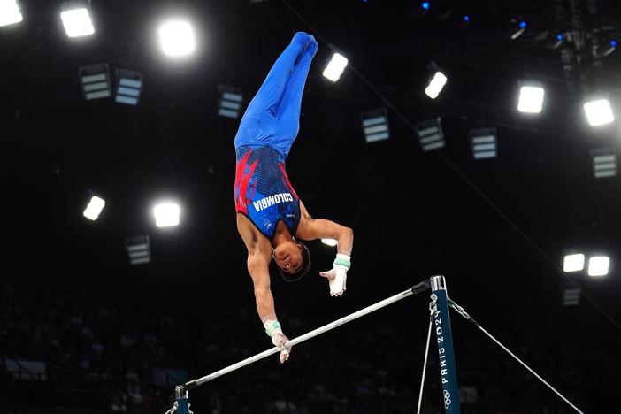 Colombia's Ángel Barajas jumped over fences as a kid, was spotted and sent to gymnastics club — and has now won Colombia's first medal in the sport. Here he is during the Men's Horizontal Bar Final at the Paris Olympics.