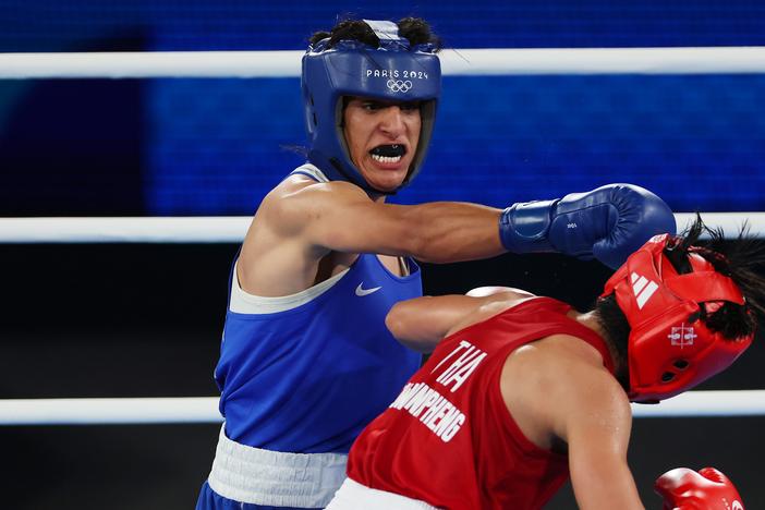 Imane Khelif of Algeria (blue) punches Janjaem Suwannapheng of Thailand during the Women's 66kg semifinal bout on Tuesday at the Paris Olympic Games.