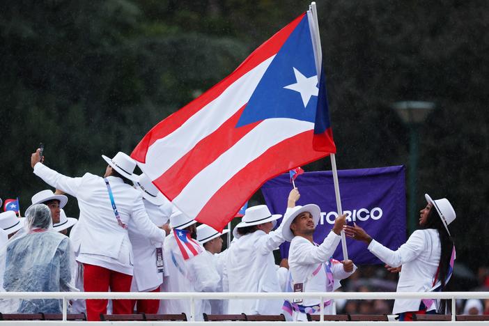 Athletes of Team Puerto Rico are seen on a boat on the River Seine during the opening ceremony of the Olympic Games in Paris on July 26.