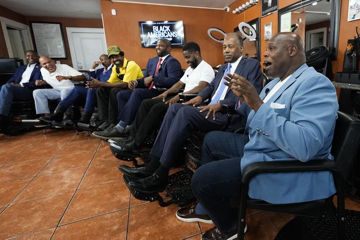 Participants speak during an event June 26 at Rocky's Barber Shop in Atlanta, hosted by the Donald Trump campaign and billed as a "Black American Business Leaders Round Table," in advance of a presidential debate between President Biden and Trump. From left are lobbyist Rufus Montgomery, radio host Shelley Wynter, Rep. Wesley Hunt, R-Texas, Marc KD Boyd, founder of Helping Empower Youth, Rep. Byron Donalds, R-Fla., Rocky Jones, barbershop owner, Ben Carson, former secretary of Housing and Urban Development…