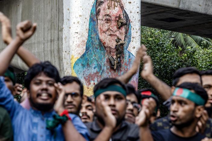 Students protest near a vandalized mural of Bangladesh's ousted Prime Minister Sheikh Hasina, demanding accountability for Hasina, near Dhaka University on Monday.