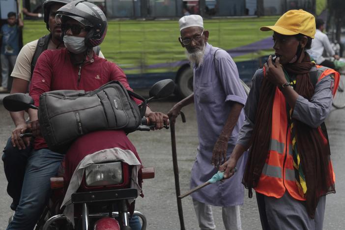 Shahana Akhtar, 26, directs traffic at a busy intersection in Dhaka, wearing her scout uniform to project authority. Akhtar supported the students’ movement to oust Bangladesh's former prime minister Sheikh Hasina, and hopes the new interim government will create more jobs. She says she’s never had a paid job.