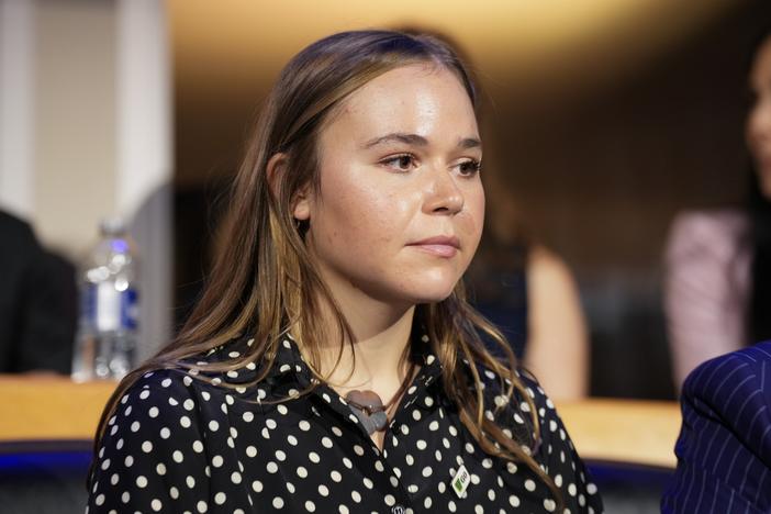 Gov. Tim Walz's daughter, Hope Walz, watches the proceedings during the first day of the Democratic National Convention on Monday in Chicago. 