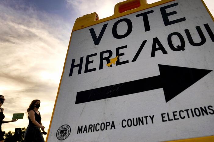 Voters walk to a polling station in Tempe, Ariz., in November 2020.