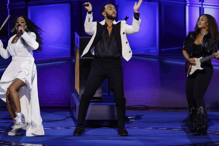 Musicians John Legend, Ari O'Neal and Sheila E. perform on stage during the third day of the Democratic National Convention in Chicago, Illinois.