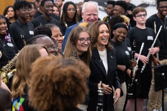 Vice President Harris and her running mate, Gov. Tim Walz, pose with members of the marching band at Liberty County High School in Hinesville, Ga., on Wednesday. 