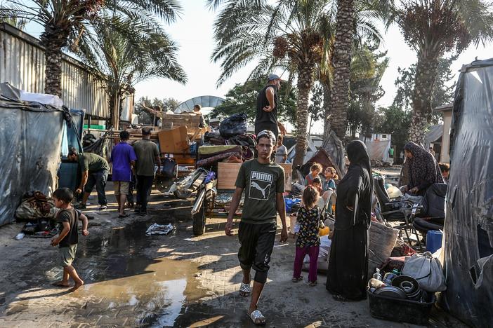 Palestinians carry their belongings on their way to migrate for safer areas following the Israeli army's warning to evacuate the Dawa Faculty of the Ministry of Endowments in Deir al-Balah, Gaza, on Monday.