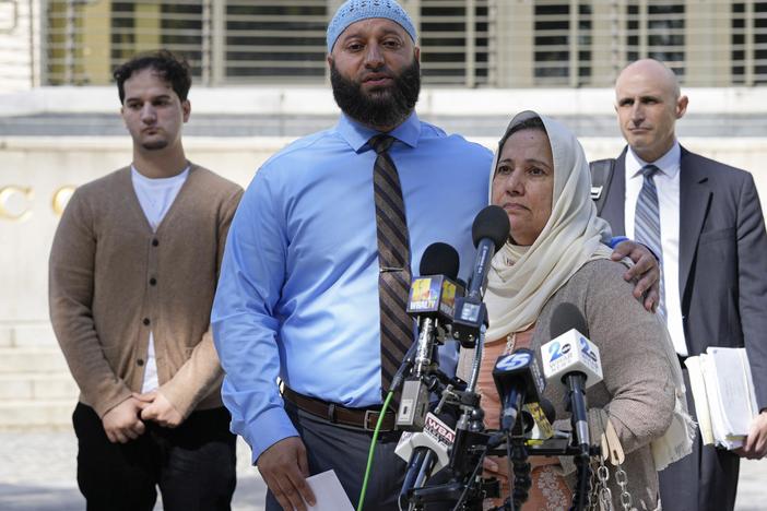 Adnan Syed, standing with his mother Shamim Rahman, talks with reporters outside Maryland's Supreme Court in Annapolis, Md., on Oct. 5, 2023.