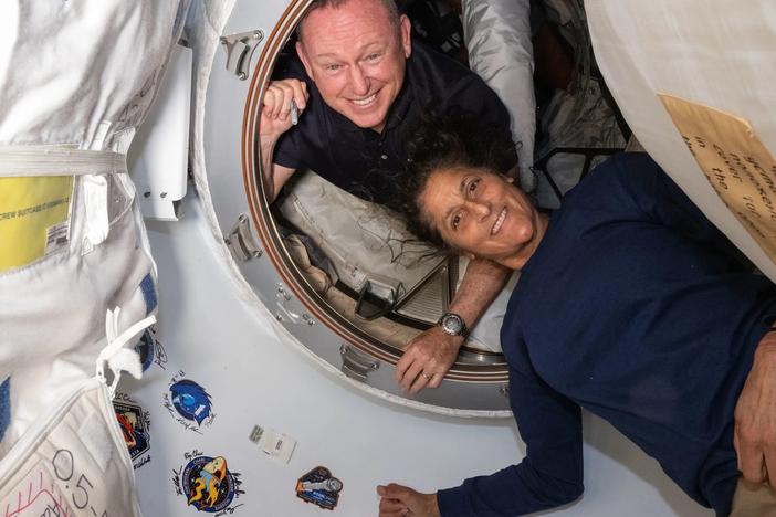 In this photo provided by NASA, Boeing Crew Flight Test astronauts Butch Wilmore (left) and Suni Williams pose for a portrait inside the vestibule between the forward port on the International Space Station's Harmony module and Boeing's Starliner spacecraft on June 13.