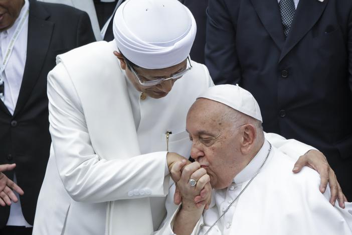 Pope Francis (right) kisses the right hand of the Grand Imam of Istiqlal Mosque Nasaruddin Umar after an interreligious meeting with faith leaders at the Istiqlal Mosque in Jakarta, Thursday.