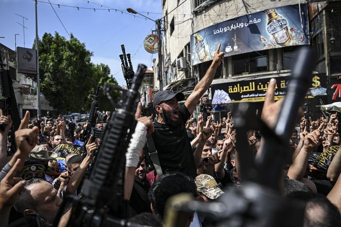 Armed Palestinian militants attend a group funeral of people killed in a raid by Israeli forces, in Jenin, in the occupied West Bank, on May 23.