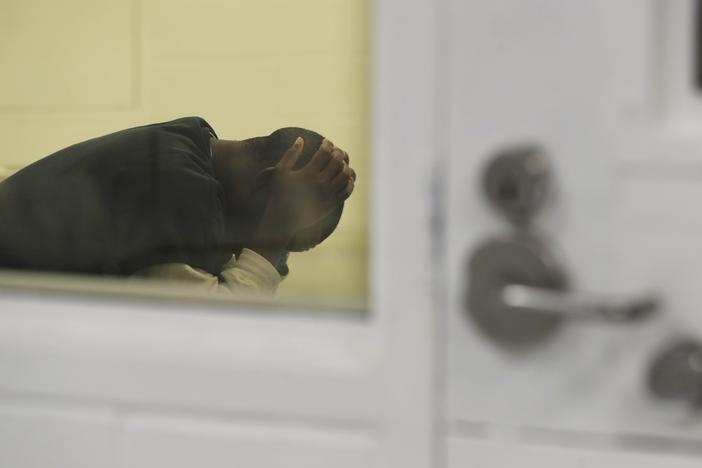 A detainee waits in a holding area during a media tour at the U.S. Immigration and Customs Enforcement detention facility in Tacoma, Wash., on Sept. 10, 2019. 