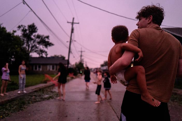 Isaiah Brown comforts his younger brother Malachi after their power went down in the Polk Street neighborhood on Sept. 11, 2024 in Houma, Louisiana.