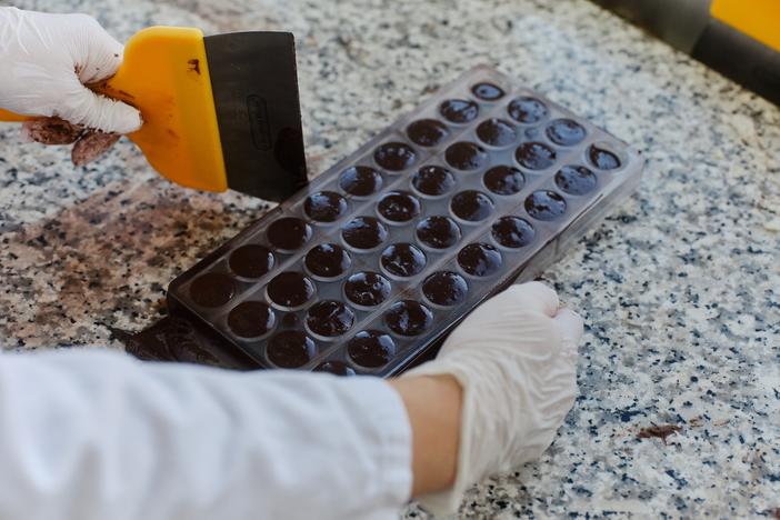 ChoViva chocolate, which is a cocoa-free chocolate alternative, is being tested and processed by an employee at the testing lab of Planet A Foods. 