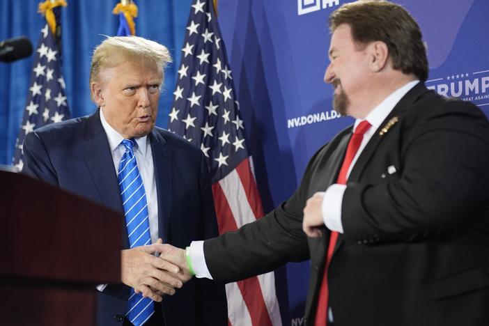 Michael McDonald, the chair of Nevada’s Republican Party, shakes hands with former President Donald Trump at a January event for Trump’s reelection campaign in Las Vegas. McDonald is one of this year’s 14 presidential electors who are linked to efforts to reverse Trump’s 2020 defeat.