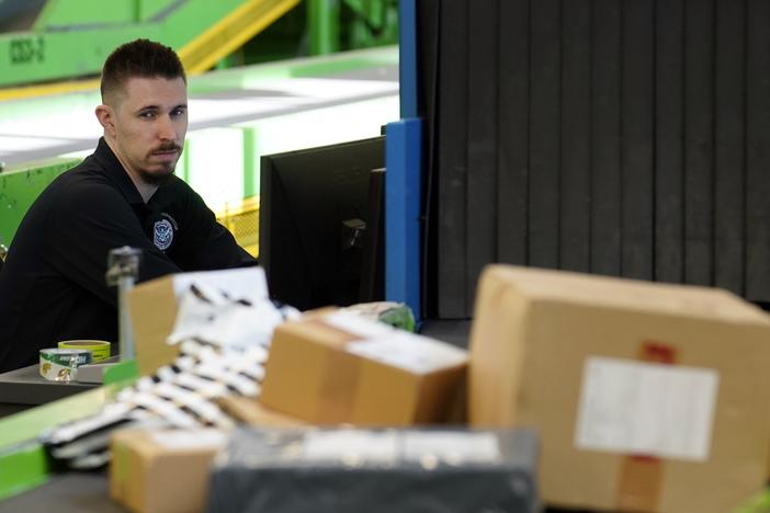 A U.S. Customs and Border Protection technician monitors overseas parcels as they get scanned at a mail inspection facility in Chicago.