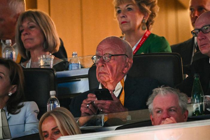 Rupert Murdoch, center, at the Republican National Convention in July. Murdoch has led his media empire to become a major player in conservative politics.