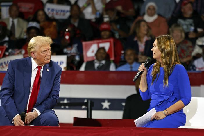 Former President Trump attends a town hall meeting moderated by Arkansas Gov. Sarah Huckabee Sanders at the Dort Financial Center in Flint, Mich., on Tues.