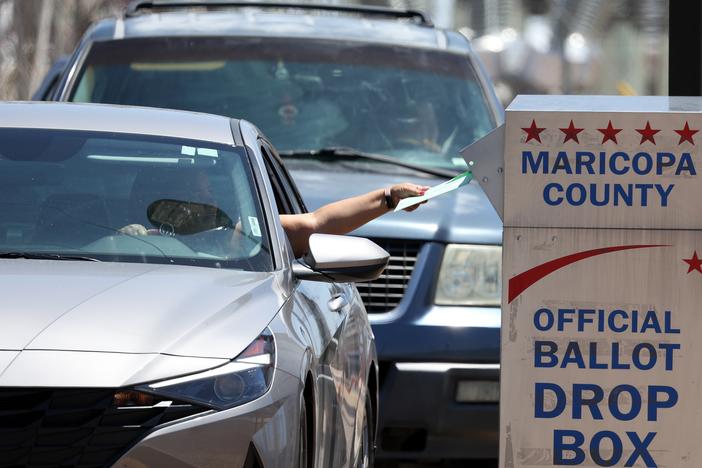 A voter places a ballot in a drop box outside of the Maricopa County Elections Department on Aug. 2, 2022 in Phoenix. A records flaw risks blocking nearly 100,000 people from voting in state and local races in Arizona in the upcoming elections.