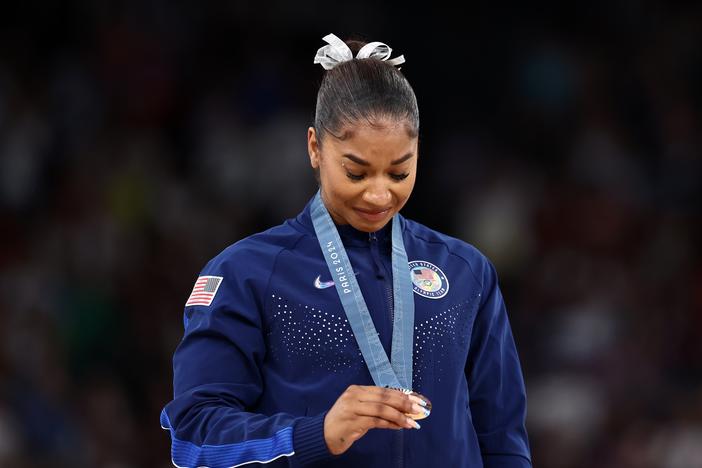 American gymnast Jordan Chiles admires her bronze medal after the women's floor final at the Paris Summer Olympics on August 05, 2024. On Monday, her attorneys filed a formal appeal with a Swiss court after a delayed appeal led to the stripping of her medal.