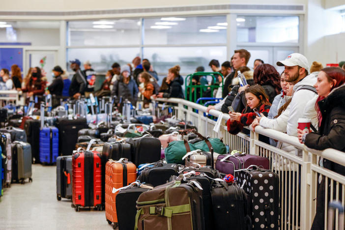 Southwest Airlines travelers wait in a long line to check on their baggage from their cancelled flights after an arctic blast and a massive winter storm dubbed Elliott swept over much of the United States in the lead-up to the Christmas holiday weekend, at Chicago Midway International Airport in Chicago, Illinois, U.S., December 27, 2022. REUTERS/Kamil Krzaczynski