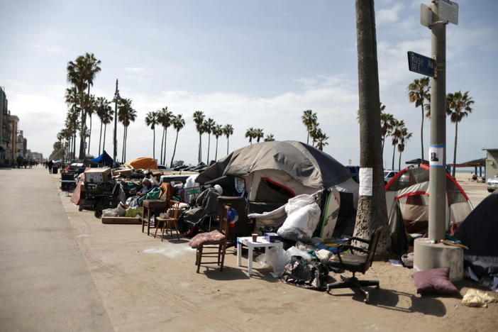 Homeless encampments line the boardwalk, as the coronavirus disease (COVID-19) disease pandemic continues, on Venice Beach in Los Angeles, California, U.S., April 14, 2021. Picture taken April 14, 2021. REUTERS/Lucy Nicholson