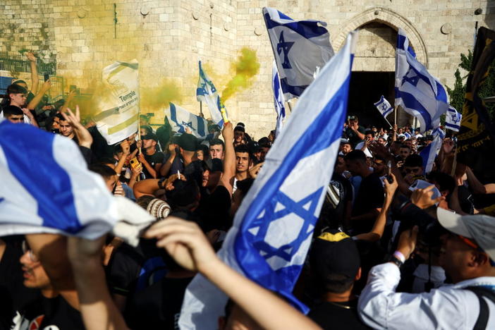 Israelis dance and sing while they hold Israeli national flags by Damascus Gatre to Jerusalem's Old city May 29, 2022. Photo by Ronen Zvulun/Reuters.