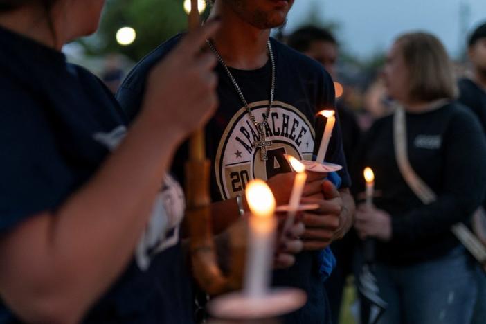 People hold candles during a vigil following the shooting at Apalachee High School, at Jug Tavern Park in Winder, Georgia, U.S. September 6, 2024. REUTERS/Elijah Nouvelage