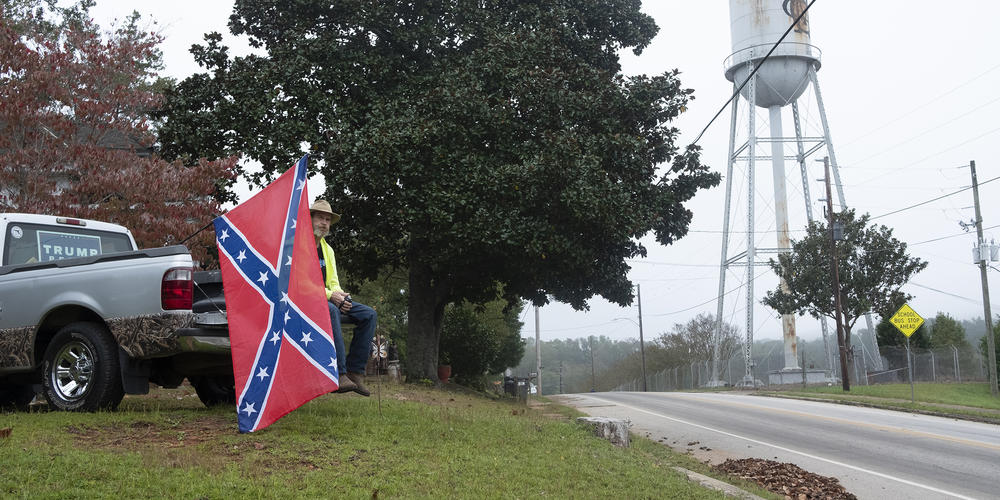 Mark Stephens watches the Trump rally in Manchester, Ga., not far from Joe Biden's speech in Warm Springs, from a hill above the event site. Stephens was asked to leave because of his Confederate battle flag. 