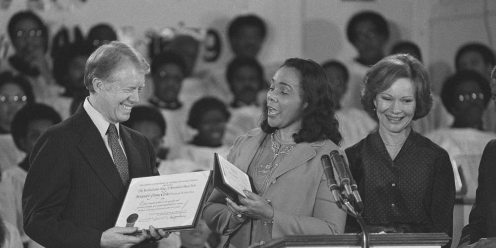 Coretta Scott King, center, widow of Martin Luther King Jr., presents the Martin Luther King Jr. Non-Violent Peace Prize to President Jimmy Carter at the Ebenezer Baptist Church in Atlanta on Jan. 14, 1979. First lady Rosalynn Carter stands with them at the podium. 