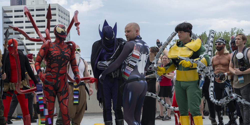 GPB's Matthew Wolff directs a photo op for "Spider-Verse" cosplayers at Dragon Con on Sept. 1, 2024.