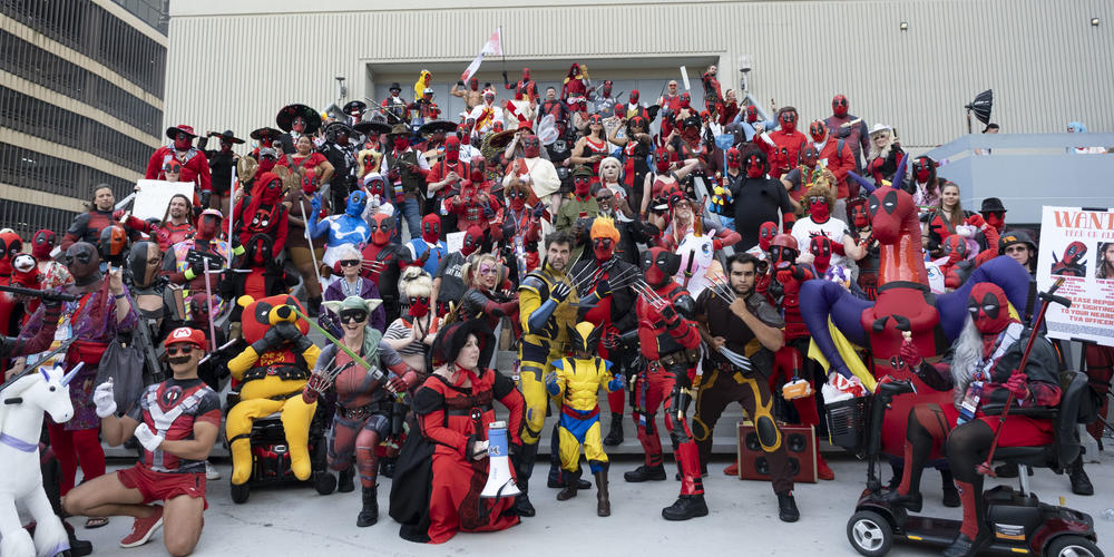 Deadpool and Wolverine cosplayers pose for a photo op at Dragon Con 2024.