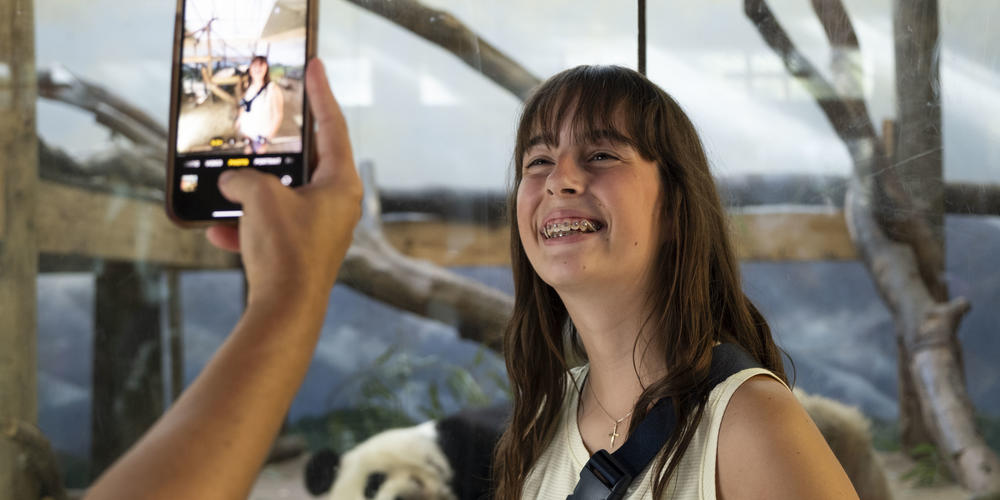 Guests at Zoo Atlanta commemorate the zoo's Giant pandas departure with a photo. 