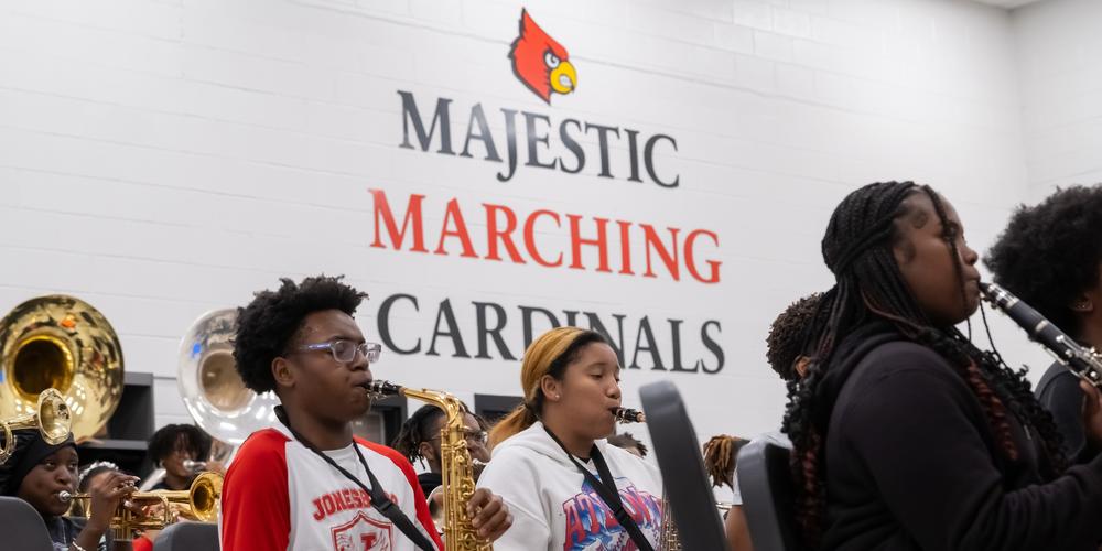 The Jonesboro High Majestic Marching Cardinals play their instruments during their final band practice before heading off to the Macy's Thanksgiving Day Parade.