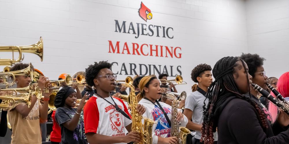 The Jonesboro High Majestic Marching Cardinals play their instruments during their final band practice before heading off to the Macy's Thanksgiving Day Parade.