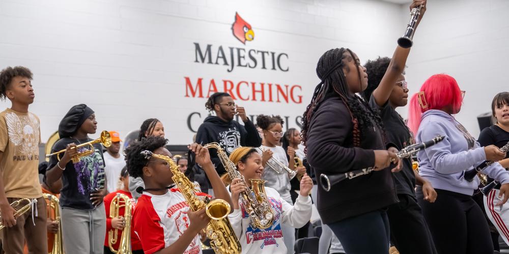 The Jonesboro High Majestic Marching Cardinals play their instruments during their final band practice before heading off to the Macy's Thanksgiving Day Parade.