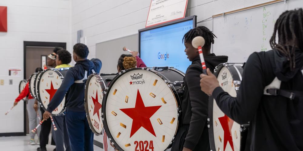 The Jonesboro High Majestic Marching Cardinals play their instruments during their final band practice before heading off to the Macy's Thanksgiving Day Parade.