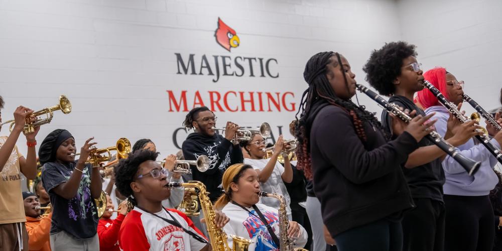 The Jonesboro High Majestic Marching Cardinals play their instruments during their final band practice before heading off to the Macy's Thanksgiving Day Parade.