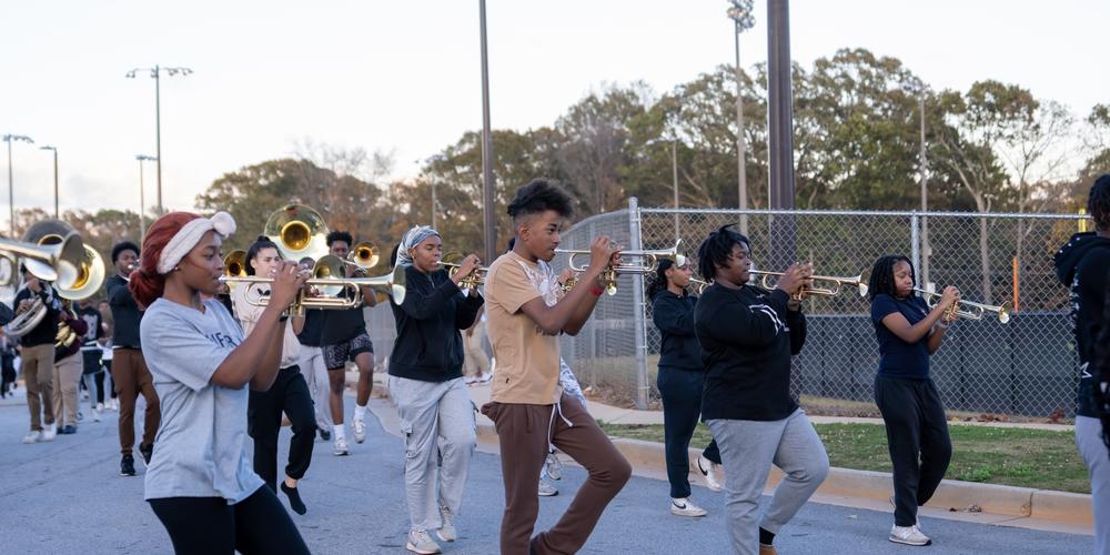 The Jonesboro High Majestic Marching Cardinals play their instruments during their final band practice before heading off to the Macy's Thanksgiving Day Parade.