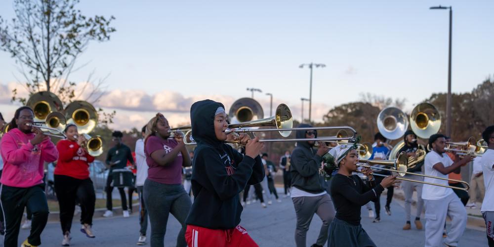 The Jonesboro High Majestic Marching Cardinals play their instruments during their final band practice before heading off to the Macy's Thanksgiving Day Parade.