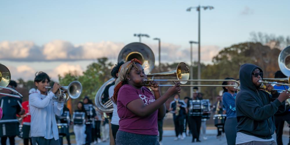 The Jonesboro High Majestic Marching Cardinals play their instruments during their final band practice before heading off to the Macy's Thanksgiving Day Parade.