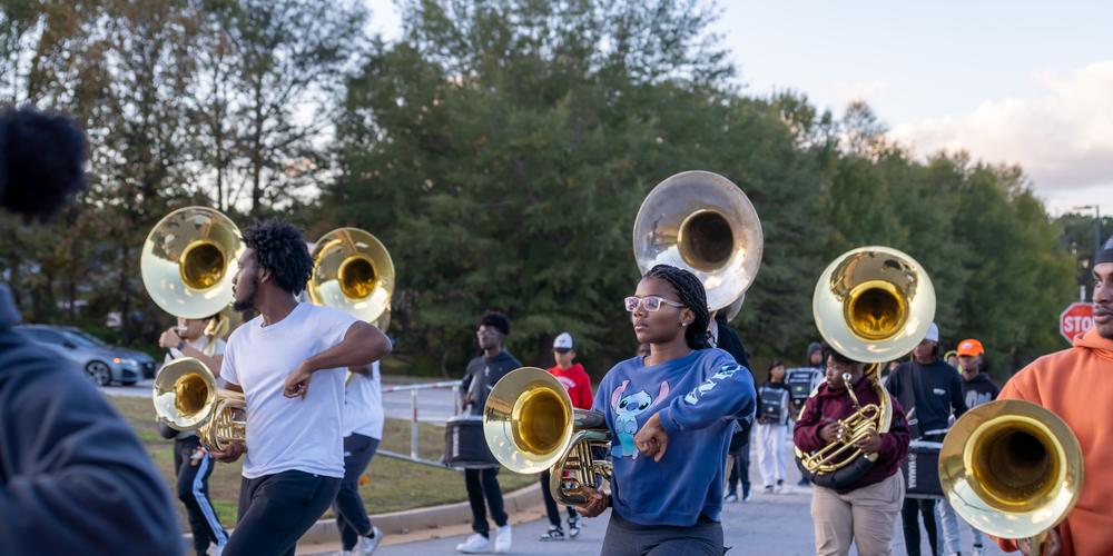 The Jonesboro High Majestic Marching Cardinals play their instruments during their final band practice before heading off to the Macy's Thanksgiving Day Parade.