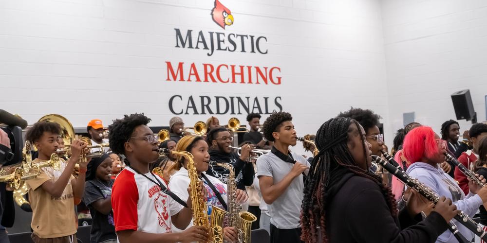 The Jonesboro High Majestic Marching Cardinals play their instruments during their final band practice before heading off to the Macy's Thanksgiving Day Parade.