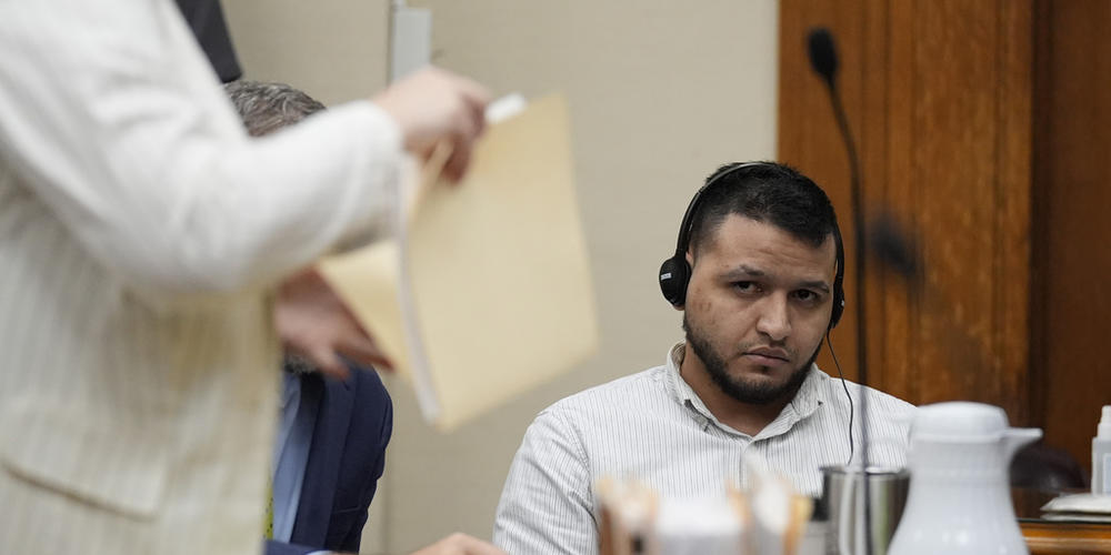 Defense attorneys Kaitlyn Beck shuffles papers in a folder as Jose Ibarra, center, accused of killing a nursing student, Laken Hope Riley, appears in court for a motion hearing on Friday, Oct. 11, 2024, in Athens, Ga. 