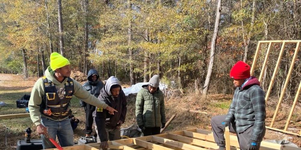 G2G Farming Lead Pele Ellis directs students in building a shed.